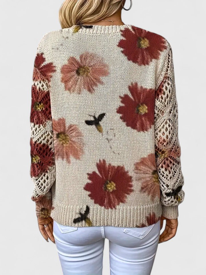 Back view of floral knit cardigan in cream with red flower print, long sleeves and ribbed V-neck