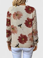 Back view of floral knit cardigan in cream with red flower print, long sleeves and ribbed V-neck