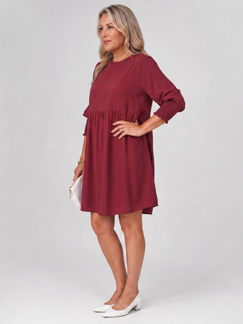 Burgundy long sleeve smocked-cuff mini dress with relaxed gathered skirt