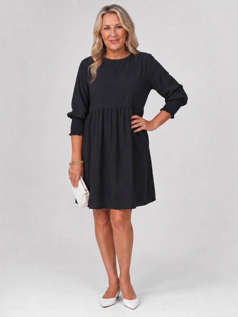 Black long sleeve mini dress with smocked cuffs and gathered skirt panel