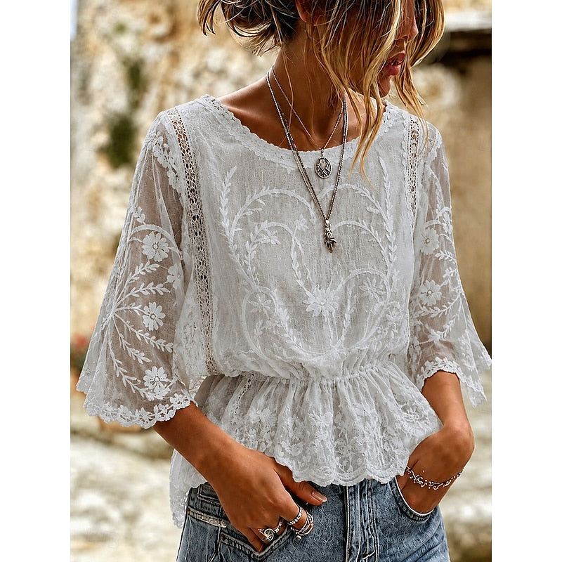 White lace-embroidered peplum blouse with lace cuffs and V-neck front