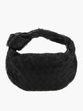 Black braided vegan leather crossbody bag with woven pattern and loop handle.