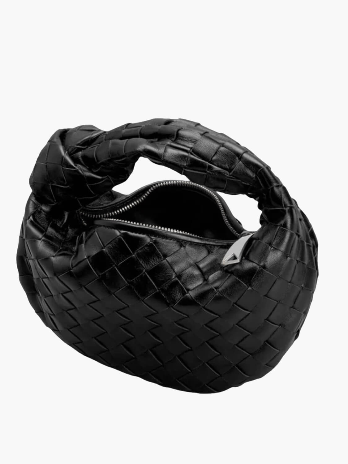 Black braided vegan leather crossbody bag with zipper opening and woven texture.