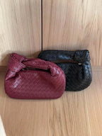 Braided vegan leather crossbody bags, wine red and black, rounded woven shape.
