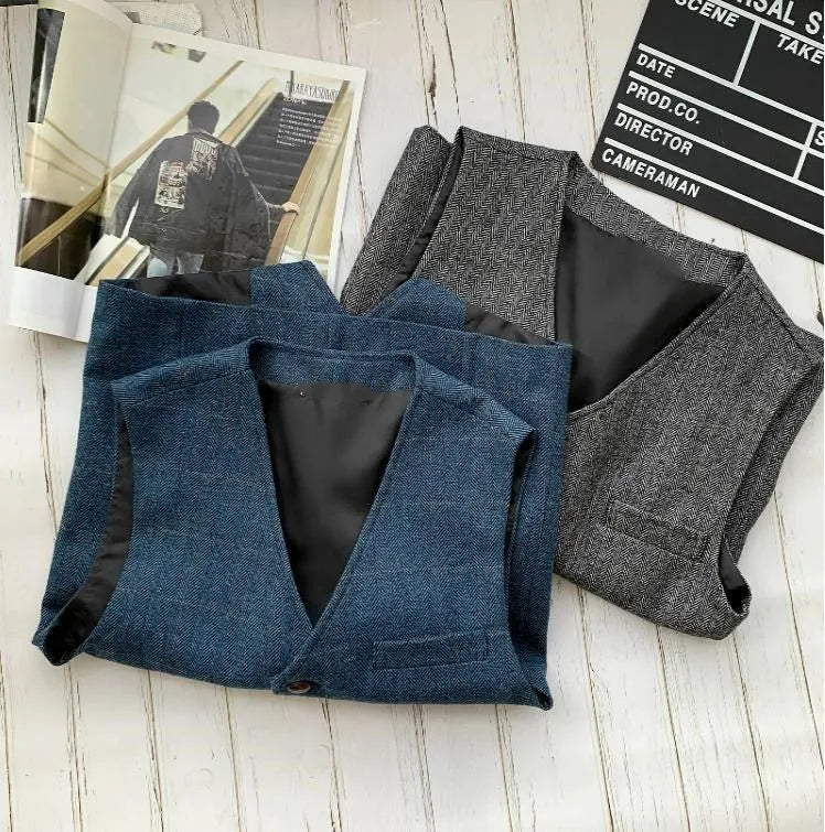 Two men's sleeveless vests: blue denim-style and gray with button front and flap pockets