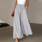 White high-waisted wide-leg trousers with elastic drawstring waist and pleated drape