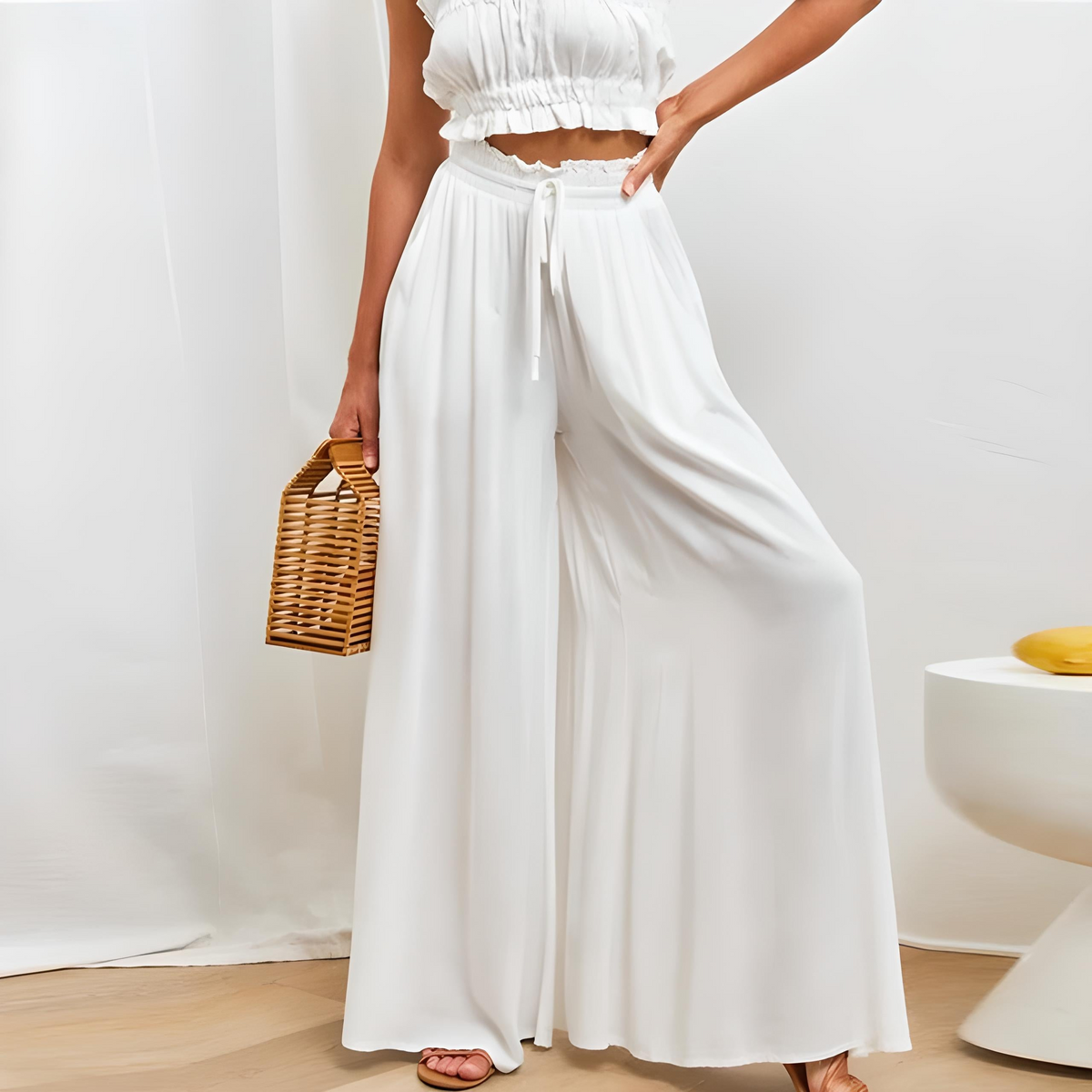 White high-waisted wide-leg trousers with elastic drawstring waist and loose flowing legs