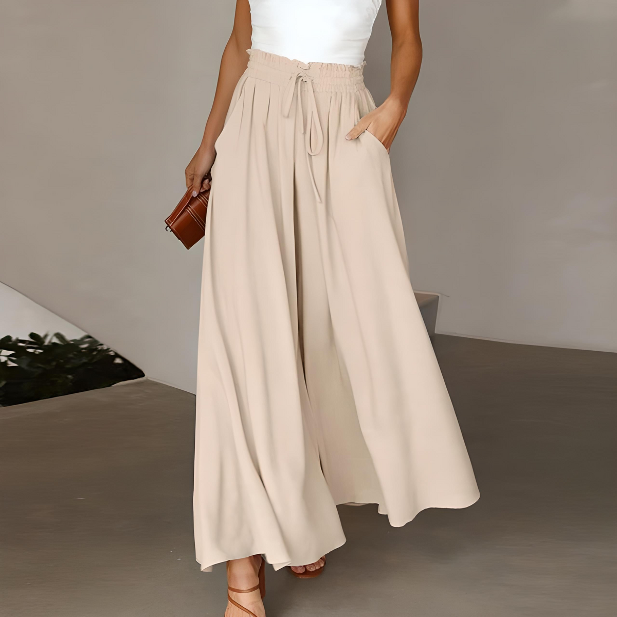 Light beige high-waisted wide-leg trousers with elastic drawstring waist and pleated drape