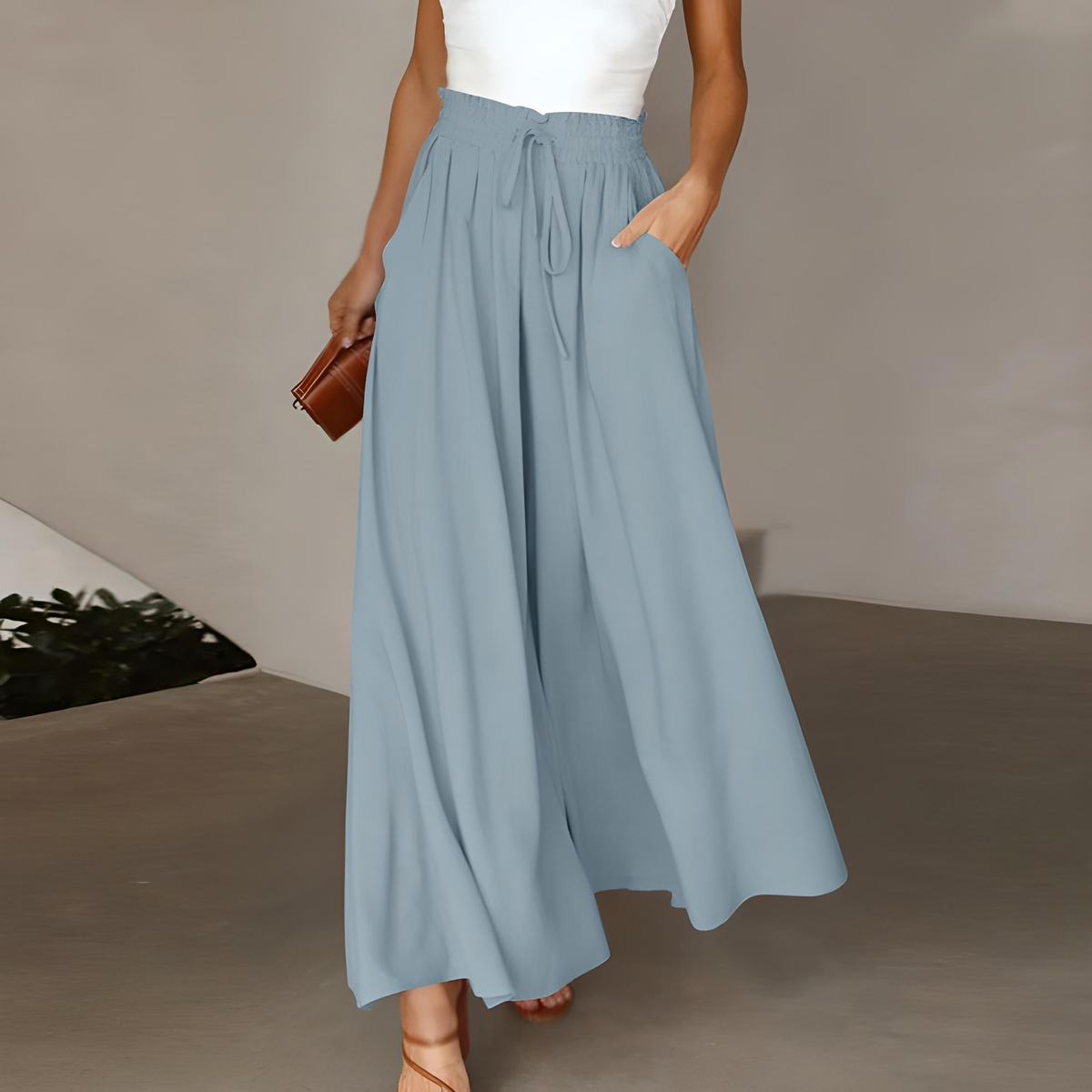 Powder blue high-waisted wide-leg trousers with elastic drawstring waist and pleated drape