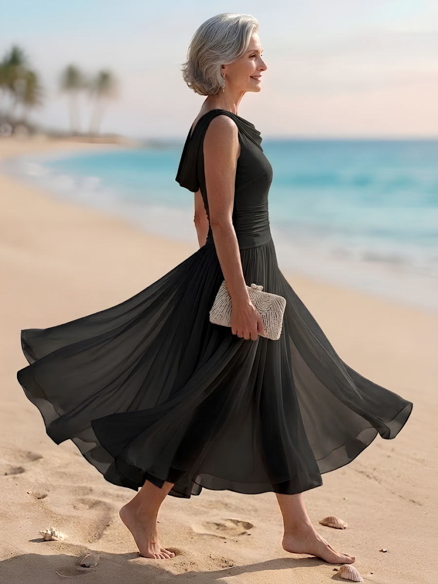 Black sleeveless pleated A-line midi dress with draped neckline, side view