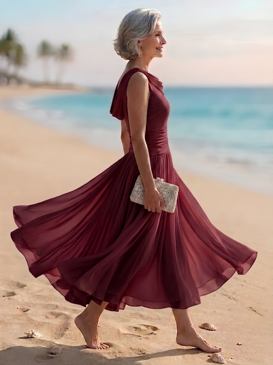 Burgundy sleeveless pleated A-line midi dress with draped neckline, side view