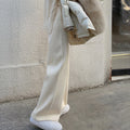 Cream wide-leg palazzo trousers, relaxed fit with flowing straight-leg shape.