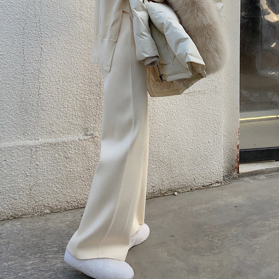 Cream wide-leg palazzo trousers, relaxed fit with flowing straight-leg shape.