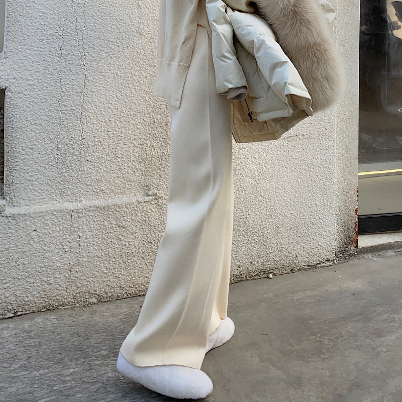 Cream wide-leg palazzo trousers, relaxed fit with flowing straight-leg shape, side view.