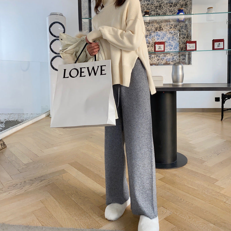 Gray wide-leg palazzo trousers with relaxed fit and soft straight-leg drape.