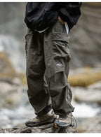 Army green relaxed cargo trousers with multiple flap pockets and cuffed hems