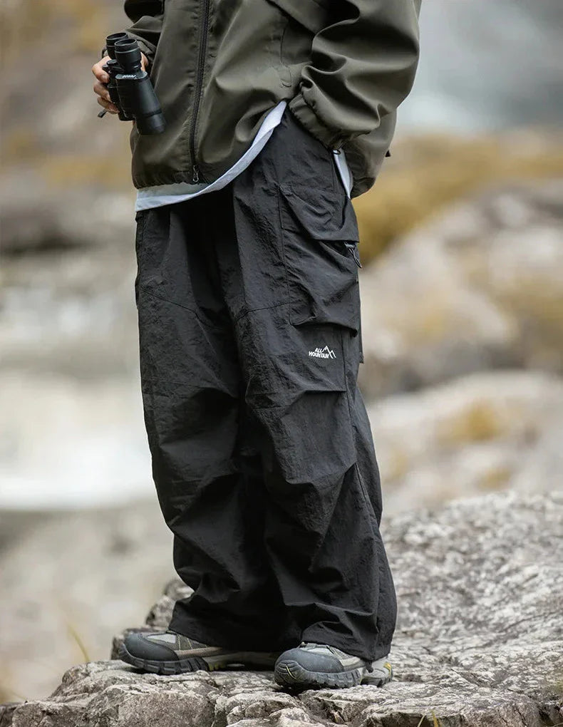 Relaxed-fit black cargo trousers with side utility pockets and adjustable cuffs