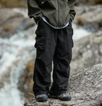 Black relaxed cargo trousers with flap cargo pocket and drawstring cuff detail