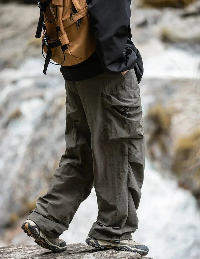 Army green relaxed cargo trousers with flap cargo pockets and cinched ankle cuffs