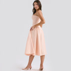Light pink corset midi dress with sweetheart neckline and full skirt with pleated volume