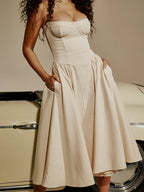 Beige corset midi dress with sweetheart bodice, spaghetti straps, and full gathered skirt