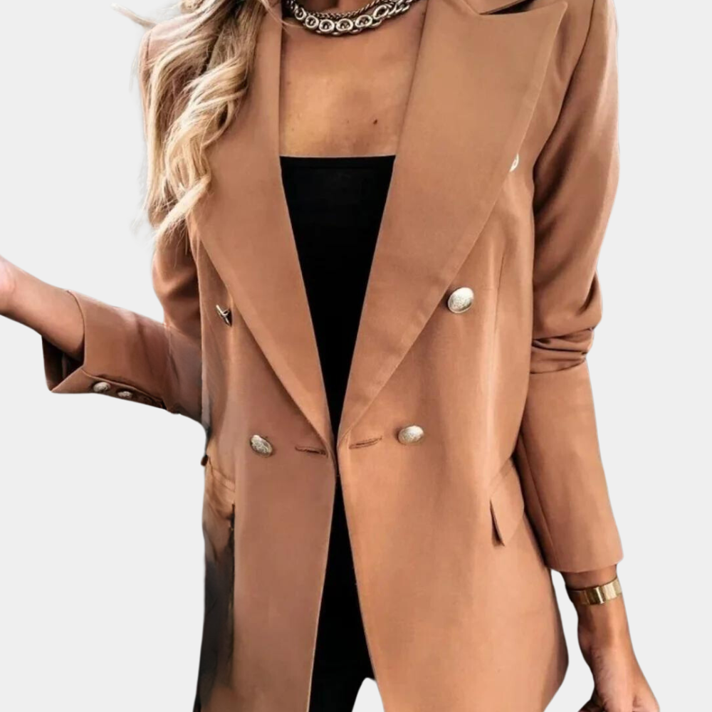 Tan double-breasted blazer with peak lapels, silver-look buttons, and flap pockets