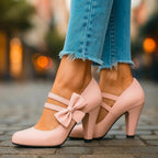 Pink bow detail heeled pumps, side view with ankle strap and mid-height heel