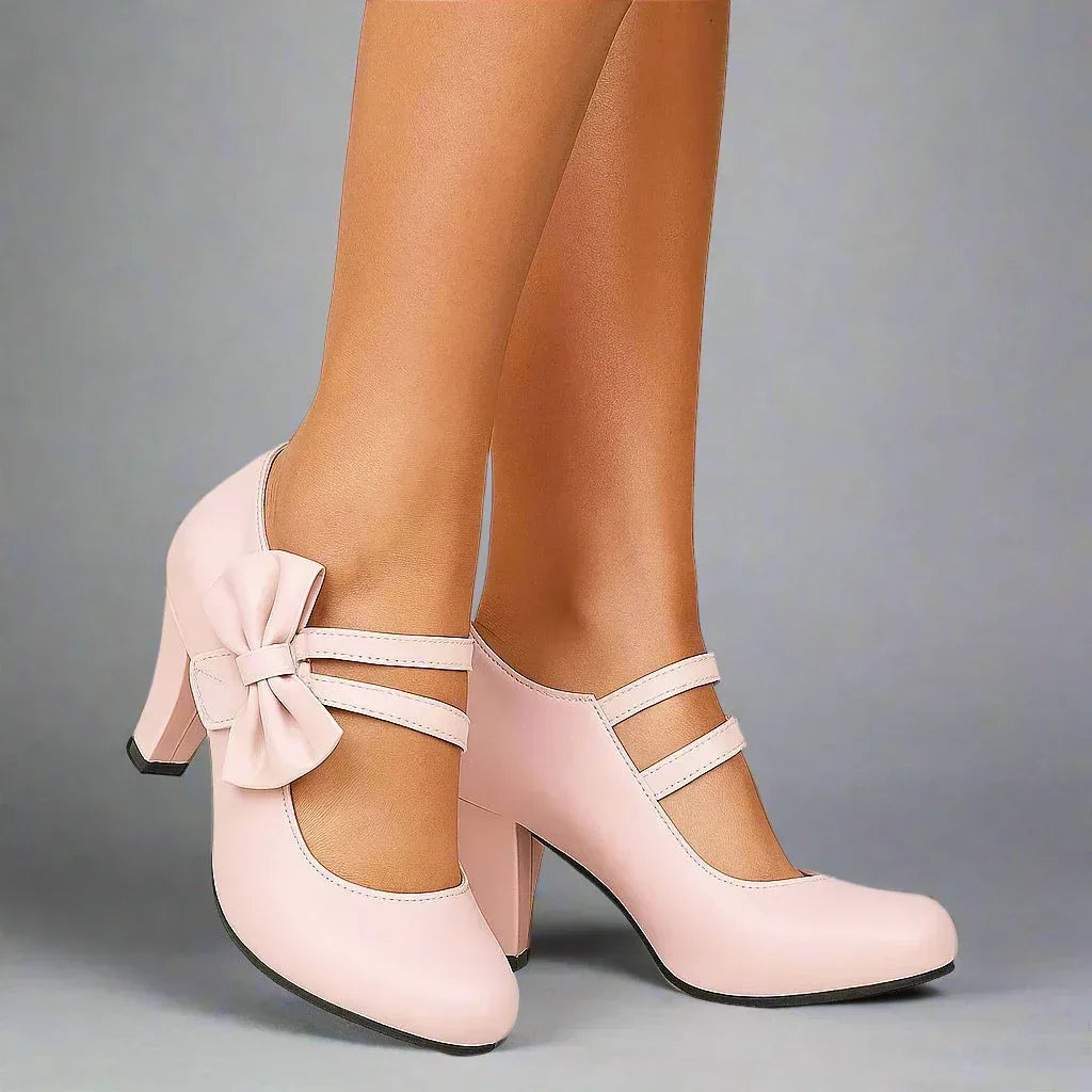 Pink bow detail heeled pumps with ankle strap and T-bar cutout, block heel