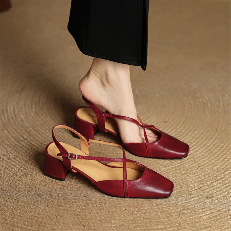 Pair of red slingback heels with crisscross straps and block heel