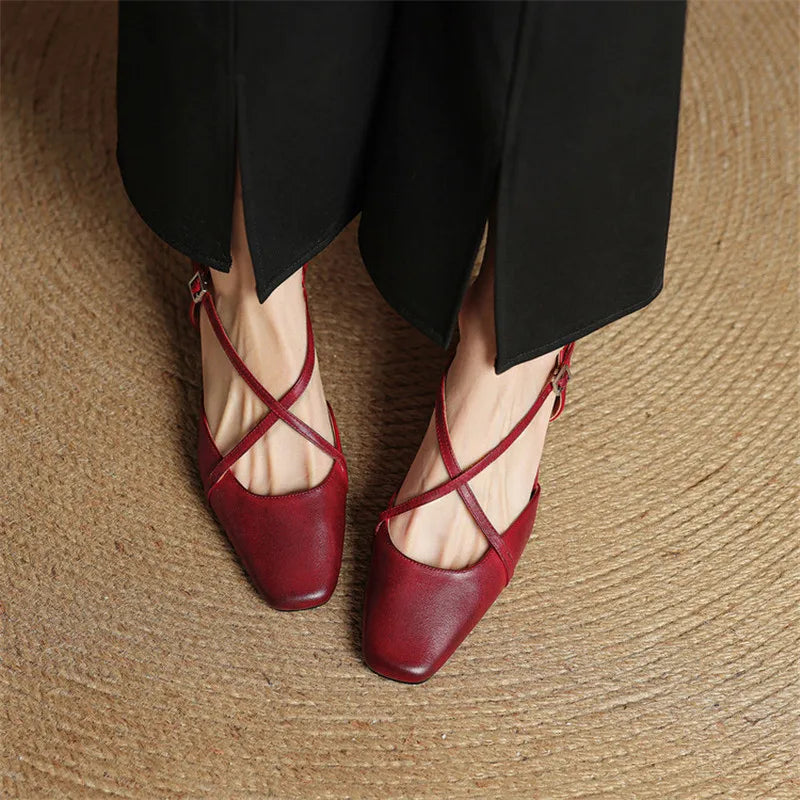 Red slingback pumps with crisscross straps and mid block heel