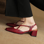 Red slingback heels with ankle strap buckle and low block heel