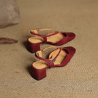 Red slingback heels with ankle strap buckle and mid block heel, side view