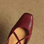 Red slingback heel with open toe and crossed straps, leather upper