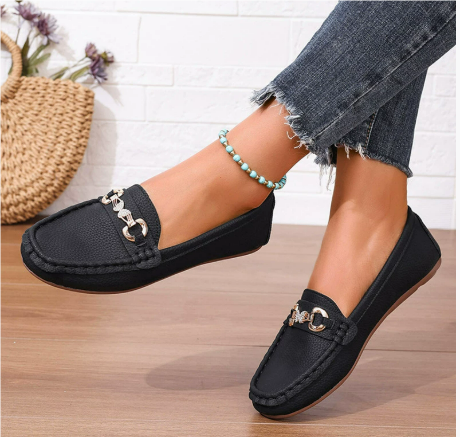 Black leather-look slip-on loafers with gold hardware detail and moc stitching