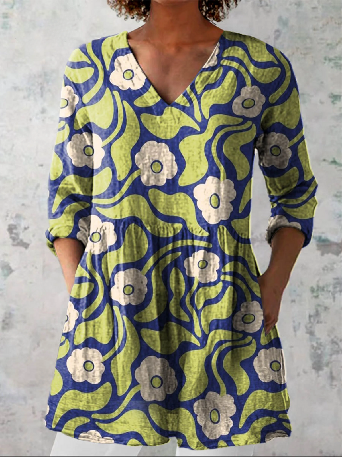 Long V-neck blouse with 3/4 sleeves, green and blue abstract floral print, button trim