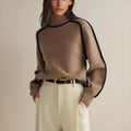 Oversized colorblock turtleneck sweater in taupe-brown with black trim, ribbed cuffs
