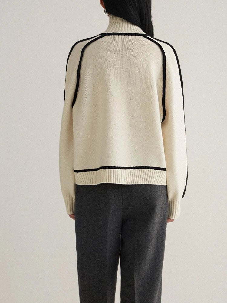 Oversized colorblock turtleneck sweater in ivory with black trim, ribbed hem