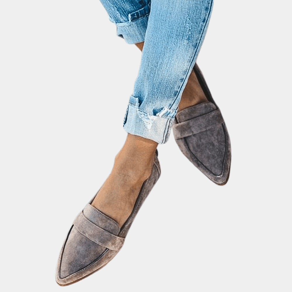 Grey suede slip-on loafer with pointed toe and low-profile sole.