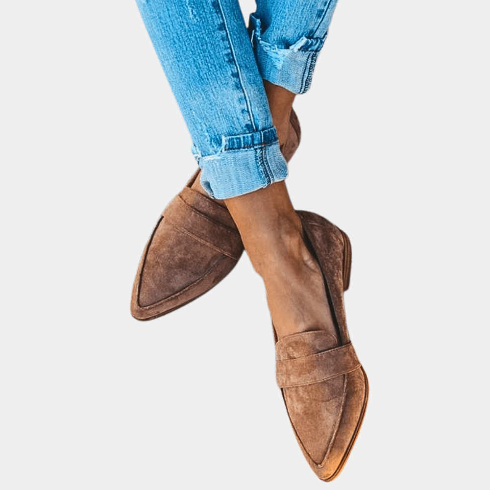 Light brown suede slip-on loafer with pointed toe and stitched strap detail.