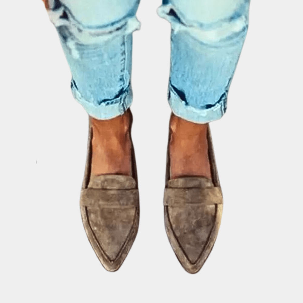 Taupe suede slip-on loafer with pointed toe and stitched paneling.