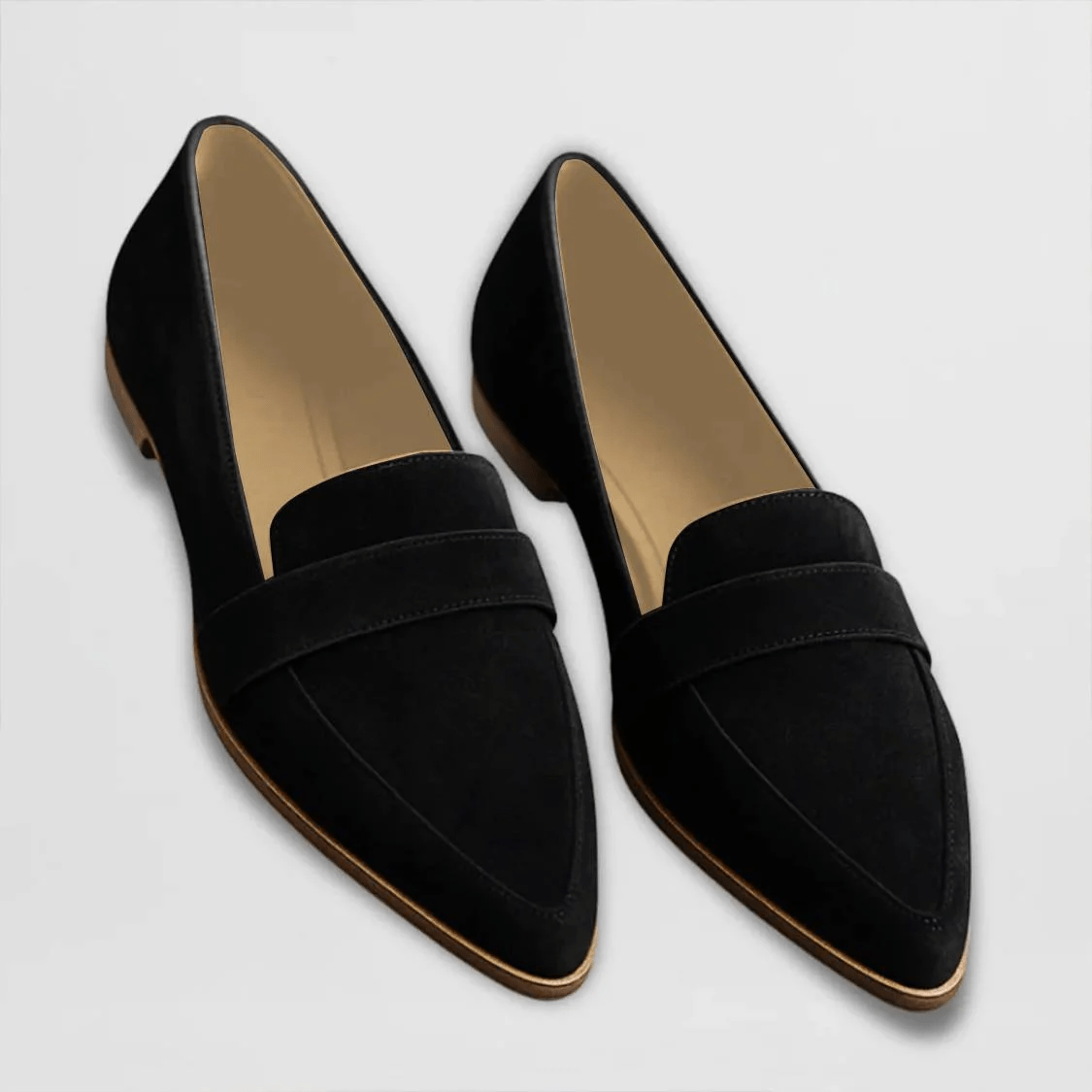 Black suede slip-on loafers with wide strap and contrast tan sole edge.