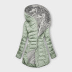 Light green hooded puffer coat with full zip, front pockets, and faux fur lining