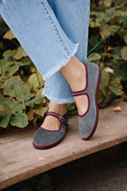 Gray women's Mary Jane flat with round toe and burgundy buckle strap and trim.