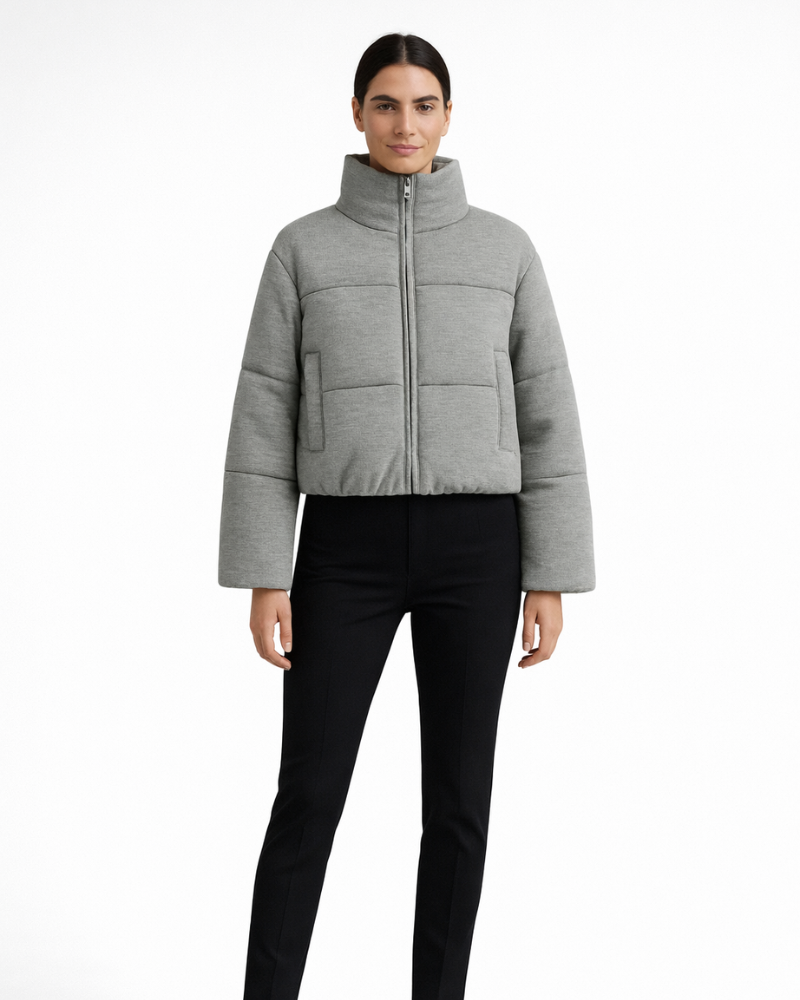 Light gray short puffer jacket with high neck and full-zip front, side pockets.
