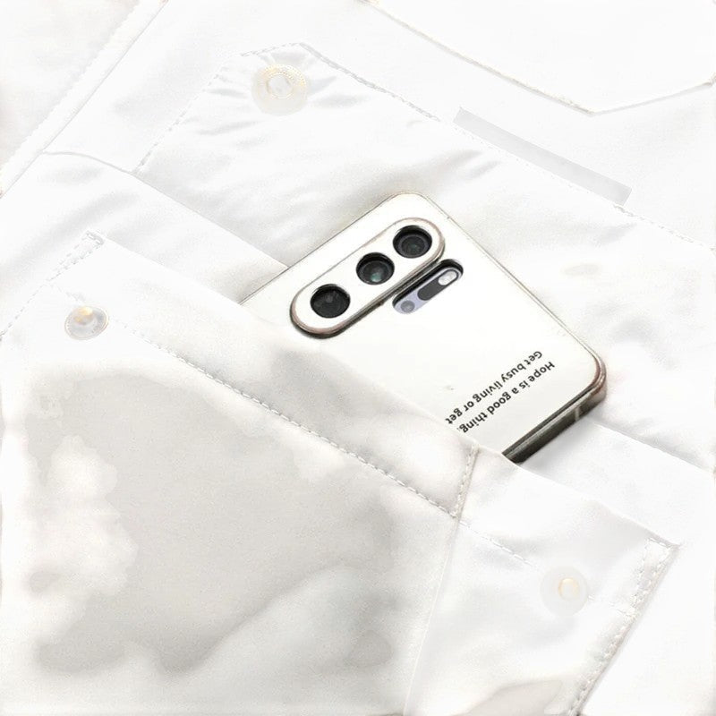 White jacket chest pocket holding a smartphone and close-up stitching