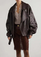 Women’s dark brown leather bomber jacket with sherpa lining and snap front