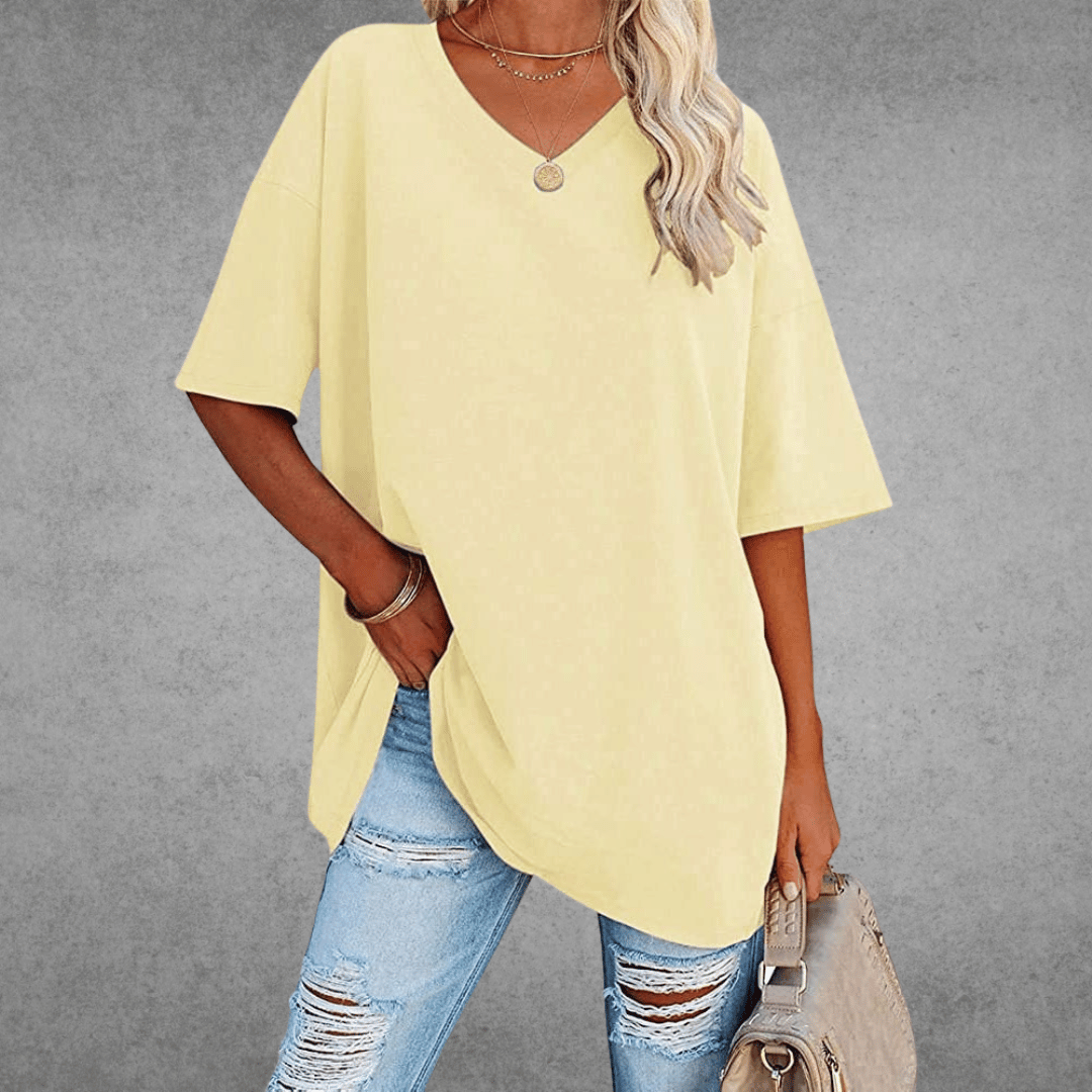 Women’s oversized V-neck T-shirt, pale yellow; loose fit short sleeves with draped front hem.