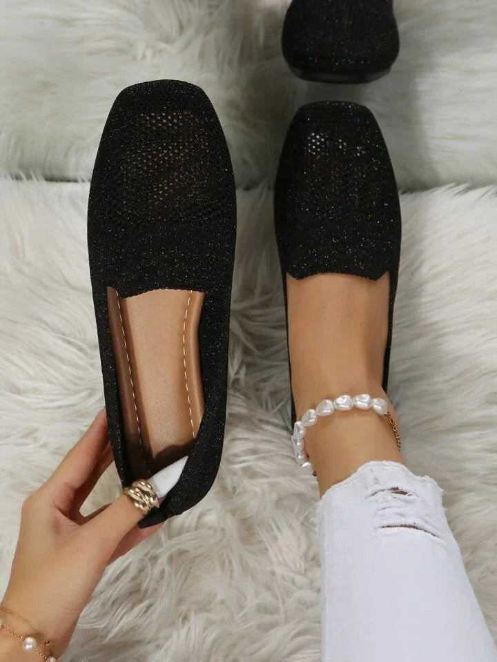 Black perforated knit slip-on loafer flats with low flat sole