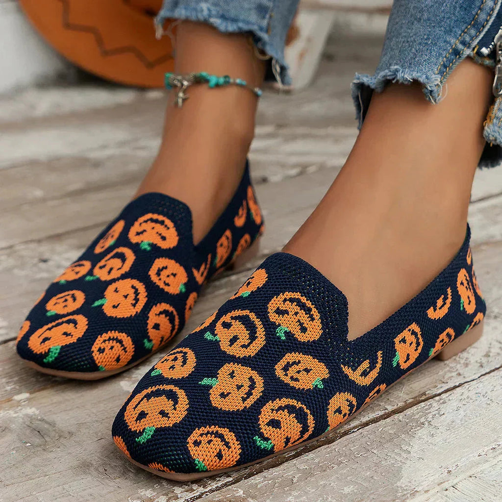 Navy perforated knit slip-on loafer flats with colorful pumpkin-style pattern