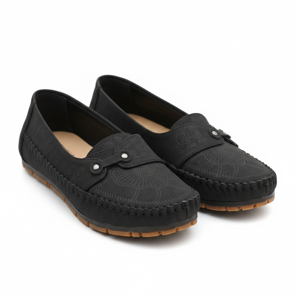 Black suede loafers with round toe, moc stitching, and hook-and-eye strap